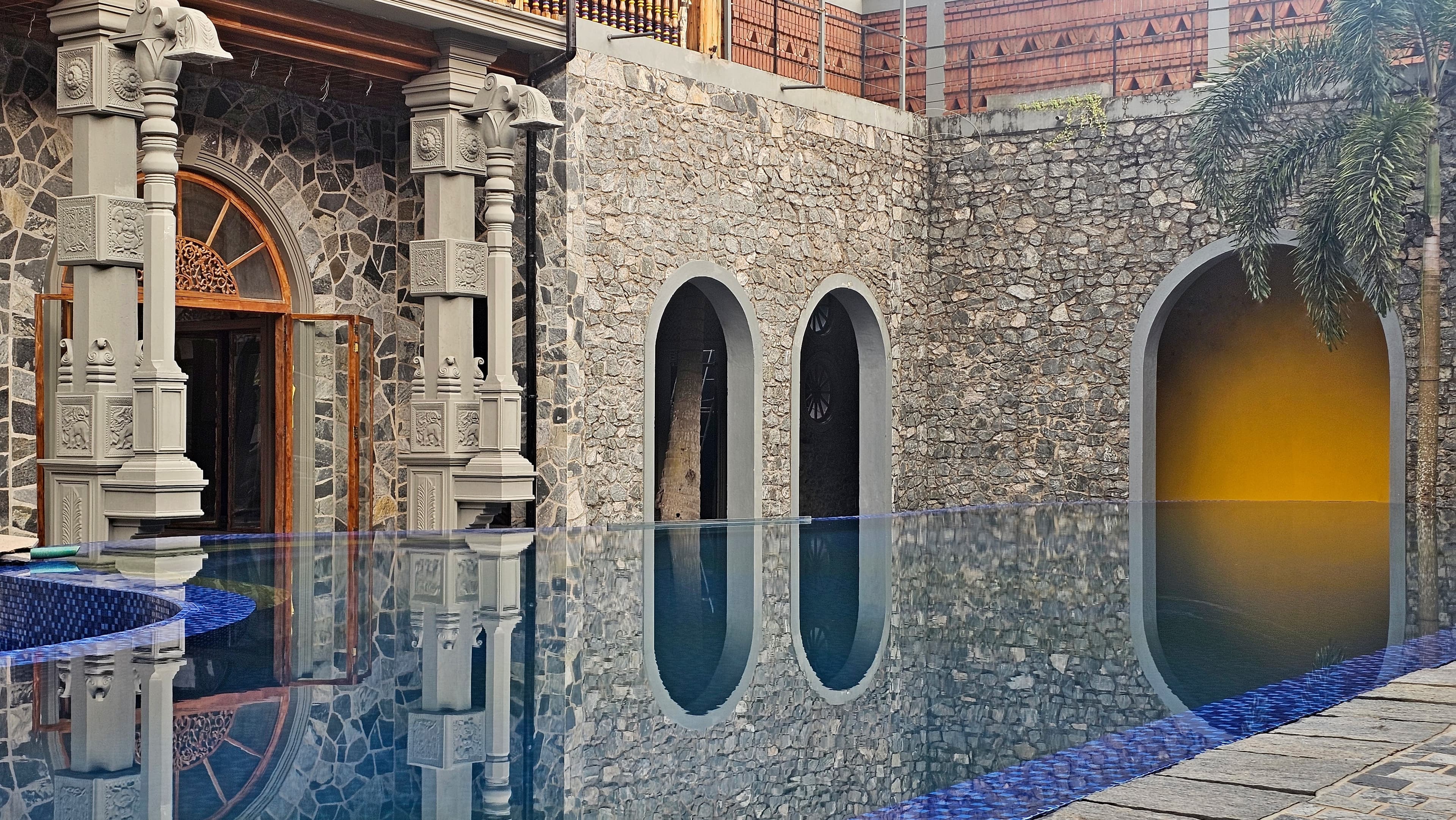 Pool with stone arches and heritage pillars